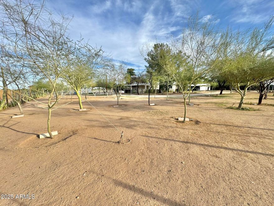 Saddle up and fall in love with this amazing horse property right across from State Land--ride out straight from your gate and hit the trails with your horses or off-road toys! The home features a 12x60 single-wide with large full-length covered patios on both sides, offering about 1,200 sq ft under roof. Inside you'll find 2 bedrooms on opposite ends and 1 full bath--perfect for privacy and comfort. Behind the home is a new RV hook up area with 35 amp. The detached 4-car carport includes big storage rooms and a mechanic's pit--ideal for projects, tools, or mechanic maintenance. Set up for 6 horses with covered stalls, enclosed tack/bunk rooms, turnout pen, mature trees, RV gate, and no HOA--this one has it all including a tortoise.