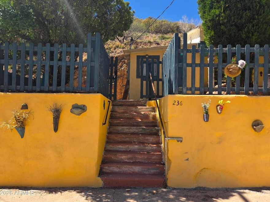 A Santa Fe feel in Old Bisbee. 2 Bedrooms, with private baths. One bedroom on each end of the house. Large kitchen, dining and living area are shared in a extended layout. The house has been completely renovated, including newer HVAC, standard hot water and a on-demand hot water heater for one bathroom/laundry. Picture windows display the rock face wall in the backyard. Several entrances to access different areas of the grounds. Level and independent garage also has been updated and has an EV charging station. Private setting, though addressed downtown,  welcoming and peaceful.