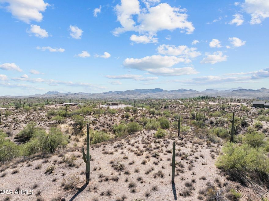 Discover a peaceful retreat on 4.375 acres of horse property nestled in the stunning Arizona desert hills. Located near the scenic Hassayampa River Preserve and abutting state land, this serene haven offers mountain views and low light pollution, making stargazing a dream. Just a short drive to Wickenburg, this property provides an ideal balance of rural tranquility and convenient access to the Phoenix Metro Area. Experience the perfect blend of natural beauty and convenience in this desert getaway.