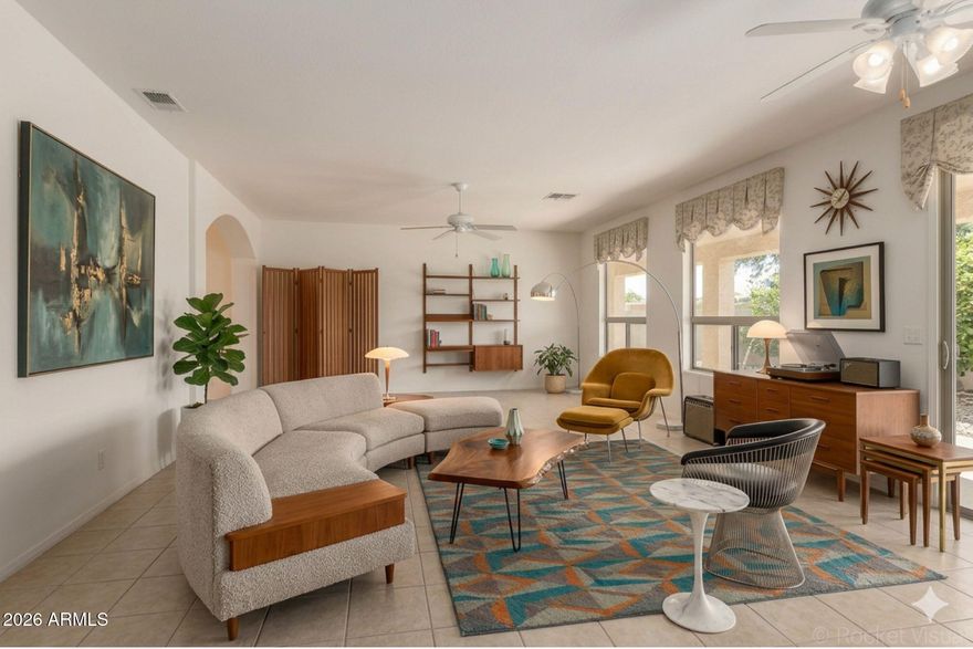 Popular 2BR/2BA + Den, Cypress model in the premier active adult community of Oakwood at Sun Lakes! Just a short stroll to the IronOaks Clubhouse, this light-filled home features a spacious great room perfect for entertaining. The open-concept kitchen boasts a breakfast bar, LG appliance package, and ample storage. Retreat to the primary suite with bay windows, walk-in closet, and dual-sink vanity. Guests will enjoy the split-bedroom layout for maximum privacy. Notable updates include a 2022 water heater, AC 2005 and a dedicated laundry room with extra cabinets. Step outside to a private backyard with mature orange and grapefruit trees. IronOaks offers world-class amenities: 45 holes of golf, tennis, pickleball, pools, fitness, and dining. Guard Gated for 24/7 Peace of mind.