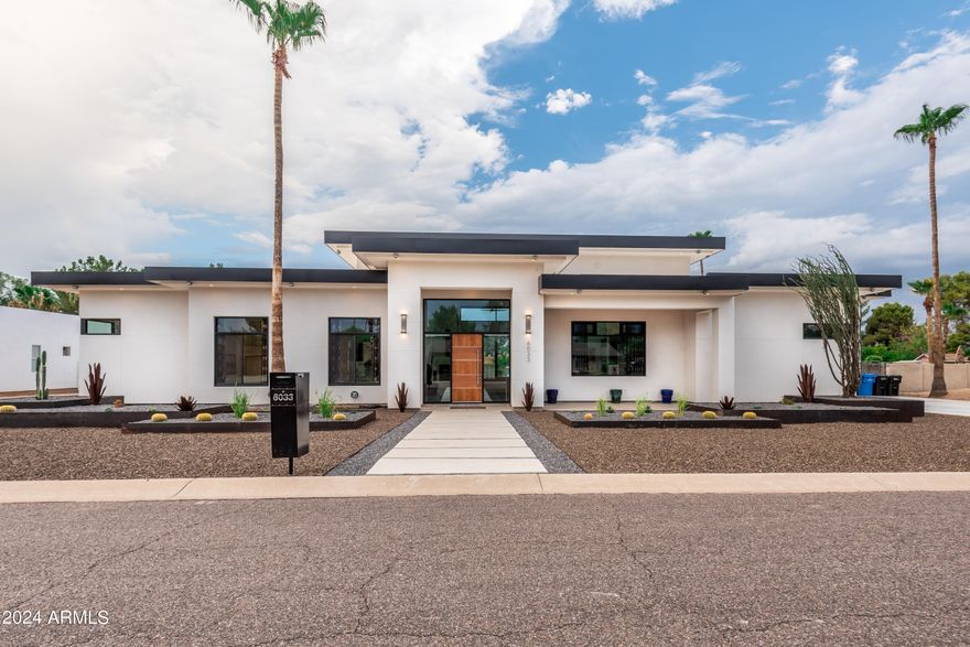 Priced Below Appraisal! Experience your very own private resort in the heart of Scottsdale! This 2017 custom-built home, situated on a sprawling over half-acre lot in the coveted 85254 area code, seamlessly blends modern elegance with comfortable living. Its stunningly unique architecture is truly a one-of-a-kind work of art.
Nestled in a serene neighborhood, this single-level 5-bedroom home spans over 4100 square feet under soaring ceilings. Upon entering, you're greeted by an inviting atmosphere flooded with natural light and an open floor plan perfect for both relaxation and entertaining.
The gourmet kitchen is a culinary enthusiast's dream, equipped with top-of-the-line appliances including a large DCS gas range with griddle and double ovens, premium Dacor refrigerator/freezer, wine refrigerator, microwave drawer, Bosch dishwasher and beautiful Quartz countertops. The expansive kitchen island allows for seating for 6 plus. A large pantry with space for additional refrigerator/freezer is conveniently situated between the kitchen and garage. An over-abundance of beautifully sleek UltraLux cabinetry insures there is no lack of storage space throughout the house. The spacious great room, complete with a gas fireplace and 17-foot ceilings, offers an ideal space for gathering with guests or unwinding after a long day. Adjacent to the great room is the perfect space for your home office.
Step out of the great room into the huge resort-style, ultra private travertine courtyard with luxurious heated pool with baja deck great for lounging the day away in our famous Scottsdale sunshine. The courtyard is an entertainer's dream with built-in gas BBQ, fireplace and firepit, dining area, putting green and above ground hot-tub, perfect for hosting gatherings or simply enjoying Arizona's beautiful weather year-round. 
The expansive Master Suite offers a spacious retreat, featuring a private sitting area where you can unwind in front of the gas fireplace and relax with a good book or your favorite movie. The spacious en-suite master bath will be your very own private spa oasis. Relax in the large soaking tub while enjoying the fireplace ambiance or indulge in a rejuvenating shower for two in the vast double shower, equipped with four shower heads, including two soothing rain shower heads. Adjacent to the master bath is a generously sized walk-in closet as well as an additional storage room that could be used as a second walk-in closet. Enjoy your own private entrance to the pool/spa area directly from the master suite.
Car enthusiasts will appreciate the expansive attached RV garage complete with a 3/4 bath, laundry hookups, utility sink, evaporated cooling and over 1700 square feet of space for storing toys, setting up a workshop, or converting into additional living space for guests or mother-in-law accommodations, rec room or home gym. 
Additional details to note include oversized windows, 17 ft ceiling in great room with 12 ft ceilings in all other rooms. Ample LED recessed lighting and ceiling fans throughout the interior and patio. An abundance of exterior lighting creates a captivating view at night, accentuating the magnificent architectural design of this home. Automated smart home features include lighting, watering, pool, thermostats and locks. Built in surround sound speakers in great room and courtyard. Entire home and RV garage equipped with fire sprinkler system. Home also equipped with Elk M1 Gold hardwired, owned security system and numerous Unifi security cameras and doorbell cameras to allow monitoring of entire exterior of the home. Swim year round with the Pentaire MasterTemp high performance pool heater. Three gas fireplaces plus firepit. Two car garage is wired for an EV charger if you choose to install one in the future. RV gate and no HOA.
Located in a prestigious north Scottsdale neighborhood with top-notch schools and close proximity to some of the valley's finest restaurants and shopping at nearby Kierland Commons, Scottsdale Quarter, the re-envisioned PV mall development, Scottsdale Airpark and the renowned TPC golf course. Welcome to luxury living at its finest in Scottsdale!