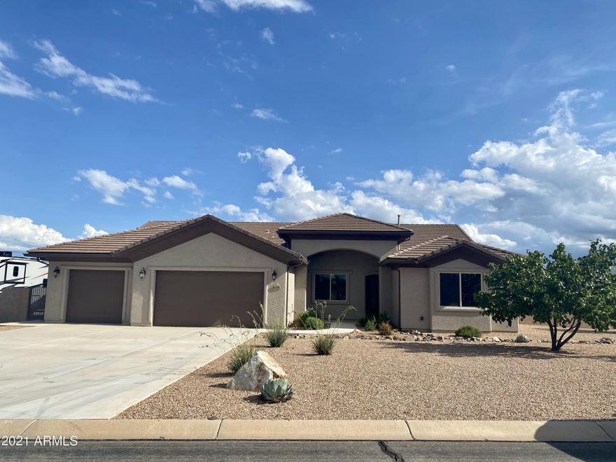 Practically brand new custom built home with all the upgrades! Open concept living with large windows and gorgeous views. This 3 bedroom 2 bathroom home includes an office with built in cabinets, wet bar in great room, updated kitchen appliances, laundry room with direct access to master closet. This home sits on one acre in the middle of Sierra Vista with plenty of space and privacy. Built in outdoor kitchen, RV parking, mature trees and large grass area with room to spare. Call today for a showing. This home will not last long!