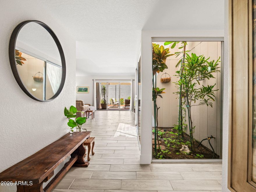 Nestled in the highly sought-after Madison/Camelback East corridor, this beautifully updated townhome offers the perfect blend of style, comfort, and convenience. Just steps from charming local coffee shops, popular dining spots, and boutique shopping, you'll love the vibrant lifestyle right outside your door. Inside, the home showcases stunning wood plank tile flooring, complemented by new baseboards for a clean, modern finish. The fully updated kitchen is a true highlight, featuring brand-new cabinetry, sleek quartz countertops, and stainless steel appliances. At the heart of the home, a gorgeous atrium fills the space with natural light, creating a warm and inviting atmosphere you won't find just anywhere. The thoughtfully designed split floor plan offers three spacious bedrooms providing both privacy and flexibility. Enjoy peace of mind with a brand new HVAC system newer roof and fresh exterior paint, adding to the home's move-in-ready appeal. Residents also have access to a community pool--ideal for relaxing and soaking up the Arizona sunshine. Located just 1.5 miles from Whole Foods, Trader Joe's, and a wide array of shopping and dining options, this home truly delivers on location, lifestyle, and livability.