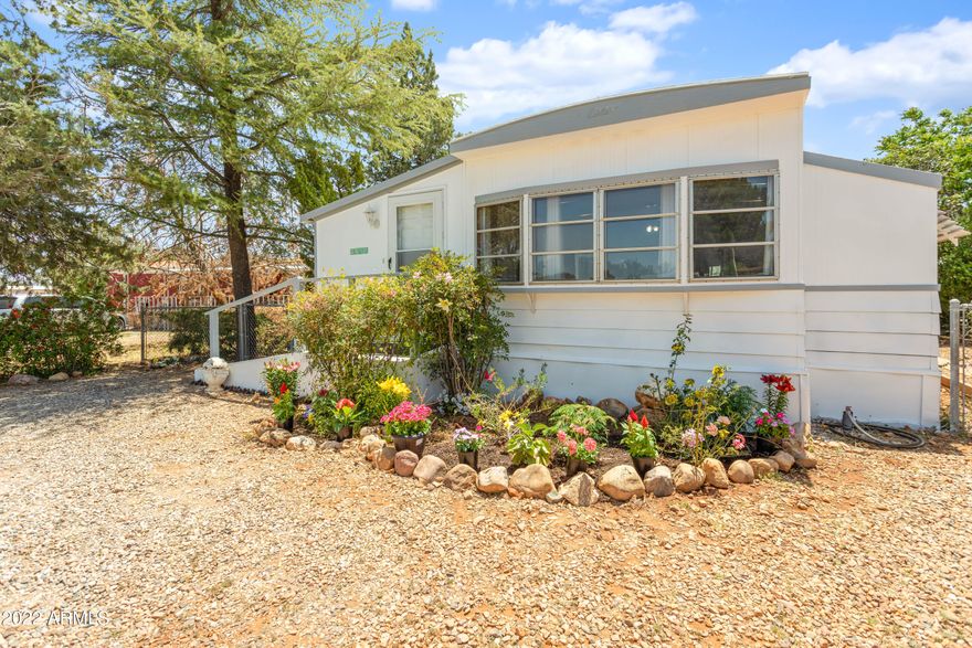 REDUCED PRICE! Priced to sell! Don't miss your chance to grab this updated gem. Attention investors: would make a great rental property! Pride of ownership throughout. Lovingly maintained and updated kitchen and bathroom, with new laminate flooring throughout. Freshly painted exterior and plenty of room in the yard to show off that green thumb! This adorable tiny home features additional usable space, with a 200 sq ft add-on AZ Room with laminate flooring, and plenty of windows for ventilation.  Move in ready and waiting to make your dreams of Arizona living come true!