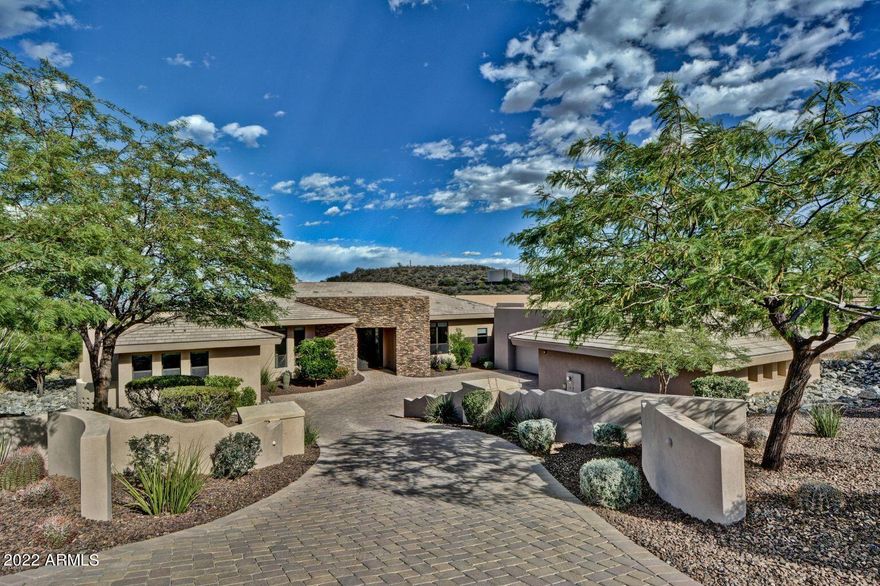 SPECTACULAR VIEWS AND IMPECCABLY MAINTAINED!! This beautiful custom home is located in the exclusive Eagles Nest guard gated community. Situated on over an acre of land and is designed in a transitional palette. You walk in to a stunning Great Room with breath-taking views of the mountains. Exquisite Great Room has a large retractable door, with a fully automated screen, pockets into the wall and a contemporary 7' long fireplace. Kitchen is a chef's dream, duel ovens and more, breakfast bar for ten. This home has 5 bedrooms, a junior master suite and an office (or 5th bedroom) with closet. The master  has a fireplace, his/her vanities, oversized shower with rain shower, body showers, built-in lounge seat, jetted tub, and large walk-in closet. Ample garage and storage space. Stunning Home!