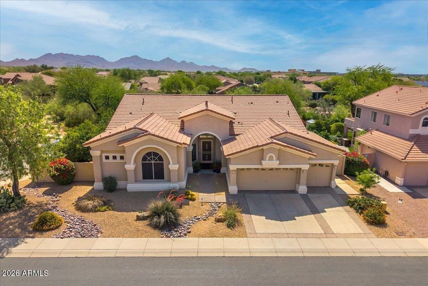 A rare find in the Desert Ridge area! This single level home sits on an oversized corner lot with only one next door neighbor & a natural desert wash behind, making it THE BEST lot in the highly desirable Sierra Pass neighborhood. As you enter the home, soaring 12  ft ceilings & expansive windows draw your eyes to the backyard oasis & the lush desert vegetation beyond the view fence. A custom-built media center is the focal point of the cozy family room with beautiful hardwood flooring that flows to the gourmet kitchen & breakfast nook. The remodeled kitchen features custom cabinetry with pull-out shelving, granite countertops & upgraded appliances including a 5-burner gas cooktop. The large primary suite offers ample space for a sitting area, a walk-in closet with California Closets custom built-ins & a beautifully remodeled bathroom with a new oversized bathtub, enlarged roll-in shower & quartz countertops. An office/library with custom-built cabinets, desk & shelving is a book lover's dream!  The guest wing includes 2 secondary bedrooms that share a jack & jill bath plus a 3rd full bathroom. A powder room is conveniently located off the main living area & a large laundry room with extra storage cabinets leads to the 3-car garage with electric vehicle charger & attached cabinets. The outdoor living space features a sparkling Pebble Sheen saltwater pool & spa enhanced by a retractable awning that provides shade beyond the large covered patio. Mature landscaping, including 4 citrus trees (Arizona sweet orange, tangelo, lemon & grapefruit), affords privacy, serenity & the occasional visit by an intrepid roadrunner!  Lovingly maintained & upgraded over the years with a new roof, new heating & cooling systems, new hot water heater & more, this home is a must see! Conveniently located just minutes from shopping, dining & entertainment at Desert Ridge Marketplace & High Street, Wildfire Golf Club, Mayo Clinic Hospital, A-rated Desert Trails Elementary School, parks, trails & easy access to Loop 101 & SR 51 freeways.