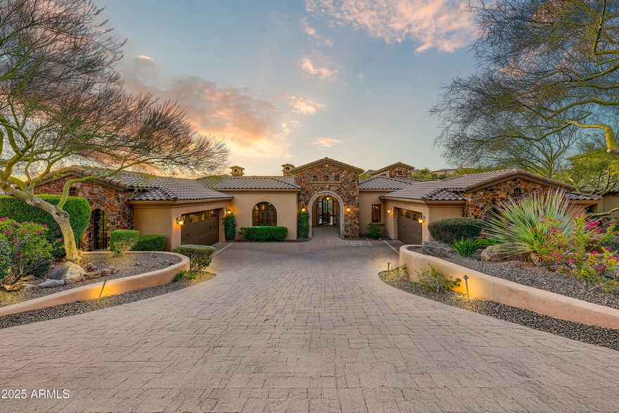 Enjoy massive golf course views from this meticulous FireRock Country Club estate. This property lives like a single level home with all major rooms on the first floor entry level. Pass the tranquil courtyard and immediately notice motorized walls of glass showcasing the emerald Golf Course beyond. An open great room is enhanced with soaring ceilings, impeccable carved carpentry, and stunning planked flooring. Open to the great room, the chef's kitchen will inspire culinary delight with dual sub-zero refrigerators, dual oven range, dinette, custom stone details and a contrasting island with tiered barstool seating. Just off the 481 bottle wine cellar, the formal dining is lined with windows and covered with fantastic arched ceilings. Relax with your favorite glass of wine while enjoying multiple terraces and patios. Compelling rejuvenation, the master retreat is complete with its own foyer, two way fireplace, private patio access, blackout shades, dual vanities, oversized jetted tub, separate stone shower, and massive walk-in closet. An additional en-suite bedroom, laundry, and incredible office with courtyard access complete the main level. Perfect for guests or family, the downstairs features three additional en-suite bedrooms, tiered movie theatre, large family room with kitchenette and an additional washer and dryer . Designed for the ultimate experience during any Sonoran season, the backyard is a true oasis with multiple open air and covered patios, a sparkling negative edge pool, bubbling spillover spa, built-in misting system, lush foliage, and more emerald views. Car enthusiasts will appreciate the two oversized and over height garages that allow for both low profile and XL sized vehicles. Additional features include a hassle free synthetic stucco exterior , multiple refrigerators, indoor/outdoor sound system, engineered elevator shaft, and much much more