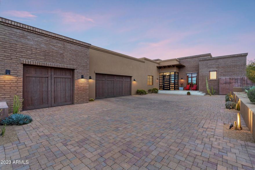 This gorgeous modern desert ranch home is light, bright, and clean w/tons of character throughout. Great architecture from the curb to the beautiful entry wood and glass doors that lead into a foyer w/10' glass windows overlooking the native desert scape. The efficient great room floor plan features the master & office/4th bedroom one one side w/2 en suite bedrooms on the other.  Separate formal dining & expansive laundry room w/3.5 oversized garage as well.  Upgrades throughout from the Wolf/SubZero SS appliances, quartz counters, stone/tile/plush carpet floors, exposed adobe brick walls, beamed ceilings, tons of tall windows, custom light fixtures & ceiling fans.  Back yard is a treat w/turf, b-in BBQ, fireplace, cozy spa, covered patio w/ TV niche , & all backing to open space w/views.