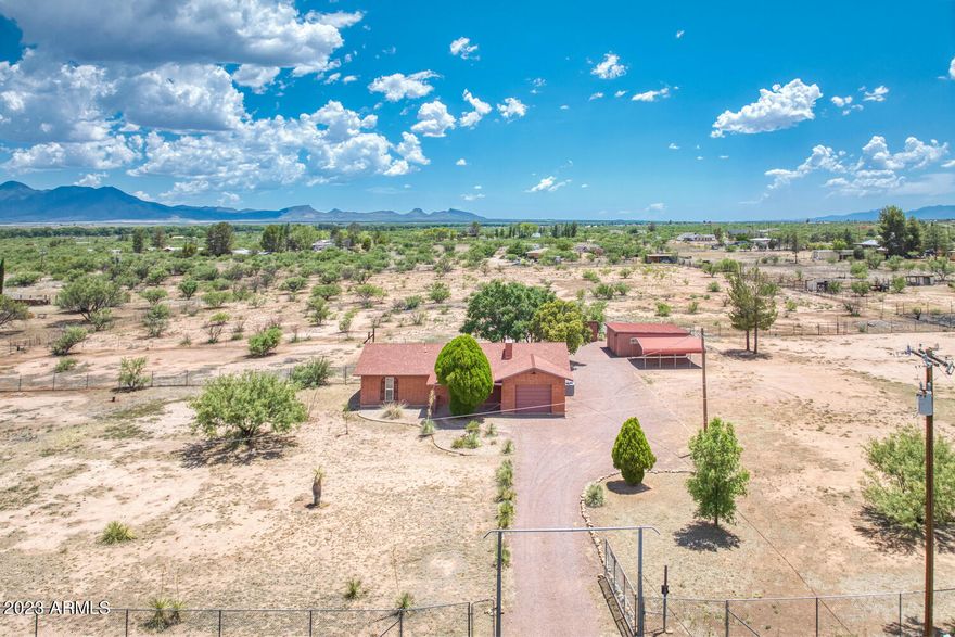 QUAINT HOME ON 6 ACRES!  Bring your HORSES! This property is fenced & cross-fenced.  It is a short distance to San Pedro River & San Pedro Riparian Conservation Area access to many horse trails. This cute Brick home  has 2 Bedrooms & 2 Baths and Central AC.  Nice wood burning fireplace in living room.  Enclosed Arizona room to enjoy the beautiful sunsets and awesome mountain views.  Detached from home is an additional 430 square foot heated & cooled building.  It would be perfect for an Office, Game Room, or Tack Room.  1 car attached garage plus a 2-car covered carport.  The property has a private well.  Plenty of room to park your RV, Boat or any other outdoor toys.   Home being sold ''AS-IS''.