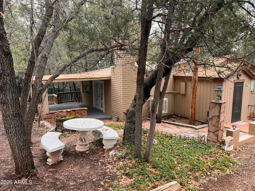 Charming cabin nestled among the tall pines in the heart of Pine, AZ! Surrounded by towering trees, this 2-bedroom, 1.5-bath retreat offers the perfect mountain escape. The spacious living room features a cozy wood-burning fireplace, ideal for relaxing on cool evenings. Beautiful wood ceilings add warmth and rustic character. Enjoy a functional galley kitchen and convenient mud room for added storage and practicality. Step outside to the covered porch and take in the fresh mountain air, peaceful setting, and local wildlife. A true getaway tucked away in the trees!