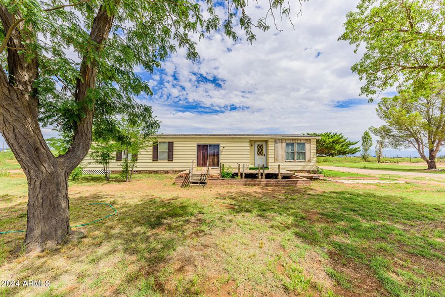 Great 4.9 acre homestead!  Plenty of room for livestock and gardens.  Large multiple room office and/or den space attached to a large 2 car garage.  Spacious 2 bedroom and 2 bath with a laundry room and walk in pantry.  Fenced and gated, mountain views and seclusion are what comes to mind.  Wide open space potential!