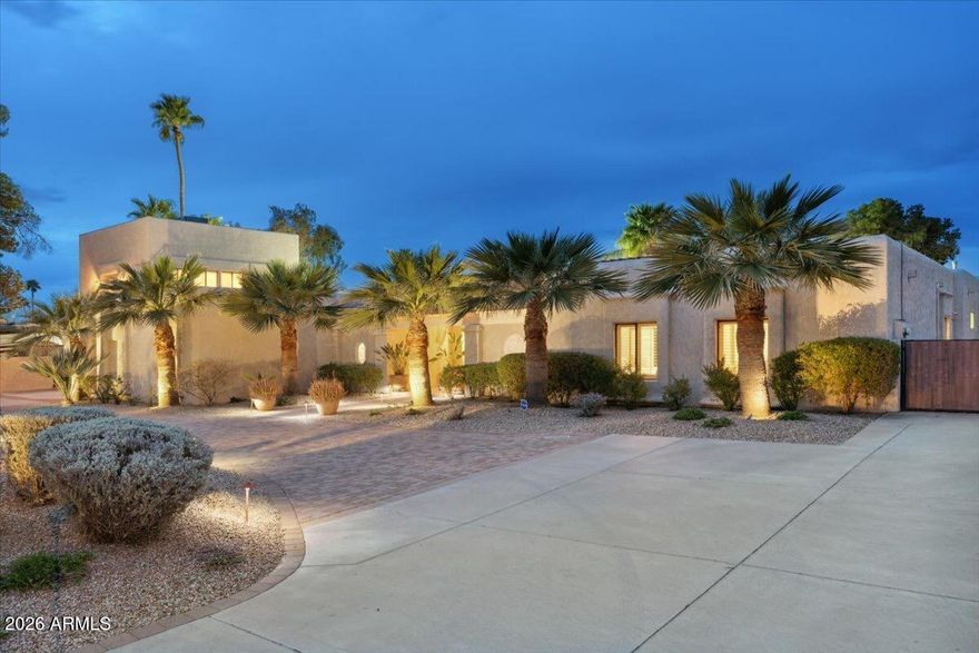 Expansive 6-7 bedroom, 5-bath luxury estate designed for multi-generational living. Includes an attached guest or in-law suite with a private 1-car garage, plus a separate studio above the detached 2-car garage complete with its own patio. The main residence features vaulted ceilings, dual-pane windows, and a full-wall sliding patio door opening to multiple covered outdoor living spaces. The resort-inspired backyard showcases a swim-up BBQ, spa, tennis court, basketball court, and mini golf area.