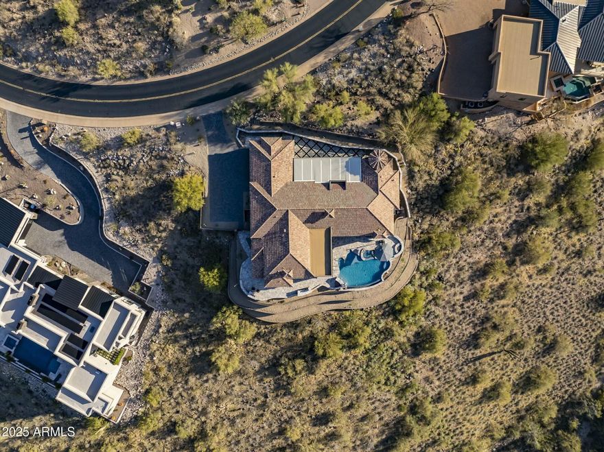 Perched on 2.3 acres in the exclusive gated community of Crestview, this stunning hillside estate offers a rare blend of seclusion, sophistication, and sweeping views of Four Peaks, Red Mountain, the iconic Fountain Hills Fountain, and the McDowell Mountain Preserve. A recently completed extensive exterior renovation has completely transformed the entire property, creating multiple outdoor living spaces designed for elevated entertaining to quiet desert evenings. The heated infinity pool and spa provide year-round enjoyment, with multiple water and fire features throughout, offering seamless transitions from indoor to outdoor living. Step inside to discover the refined desert lifestyle at its best, boasting quintessential desert views from every room. The main entrance boasts a welcoming library and dining room with picturesque views through a wall of large windows. The chef's kitchen features upscale appliances, custom cabinetry, and a walk-in pantry, flowing into a stylish family room with a statement fireplace and built-ins. The luxury primary suite is a private retreat with its own fireplace, coffee bar, and separate walk-in closets. A spa-inspired ensuite includes a jetted soaking tub, walk-in tiled shower, dual vanities, and a bidet.

Guests enjoy their autonomy in one of two private wings of this home. The first is complete with a living space, wet bar, en-suite bedroom, and separate patio access. The third bedroom is a private ensuite with spacious closet and mountain views. 

Additional features include a temperature-controlled wine room, built-in office with desk and storage, full professional interior paint, newly polished and sealed Travertine, oversized 3-car garage with epoxy flooring and built-in storage, Cat 5 Ethernet, smart home capabilities and whole house Sonos sound. 

Located just across the Scottsdale border on the most western edge of Fountain Hills, live mere minutes from BASIS School, award-winning golf, and the best amenities Scottsdale and Fountain Hills have to offer!