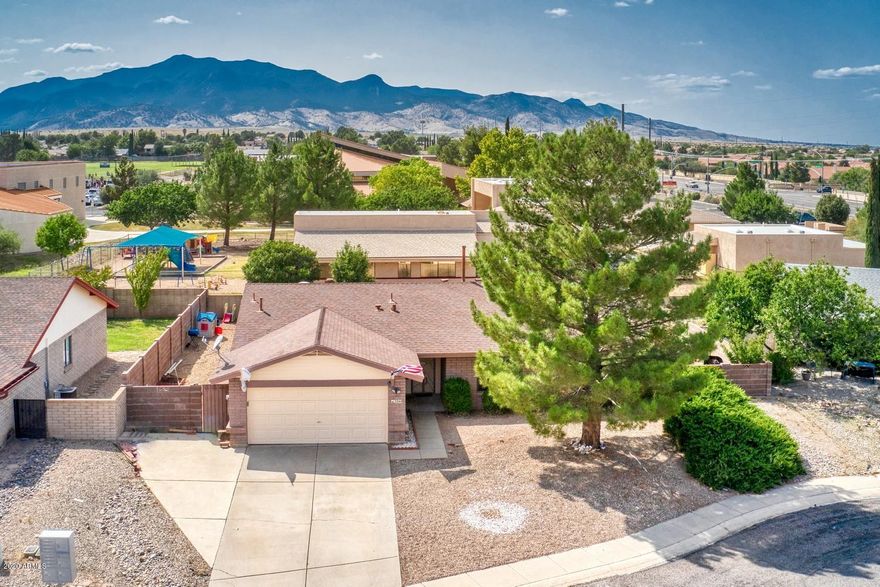 What a terrific family home!  This 3 bedroom 2 bath home has it ALL!!  Gorgeous stained concrete floors in the enormous great room, kitchen, dining room and hallways.  A brand new beautiful updated kitchen to include quality cabinets with pullouts, quartz kitchen countertops, and all new stainless steel appliances!  If the inside isn't enough, step outside to the breathtaking backyard with large heated (new heater) play pool with spa.  The backyard even has artificial turf for the kids and pets to play on, AND views of the Huachuca's!
This home has everything you could want!  It won't last long so call to view today!