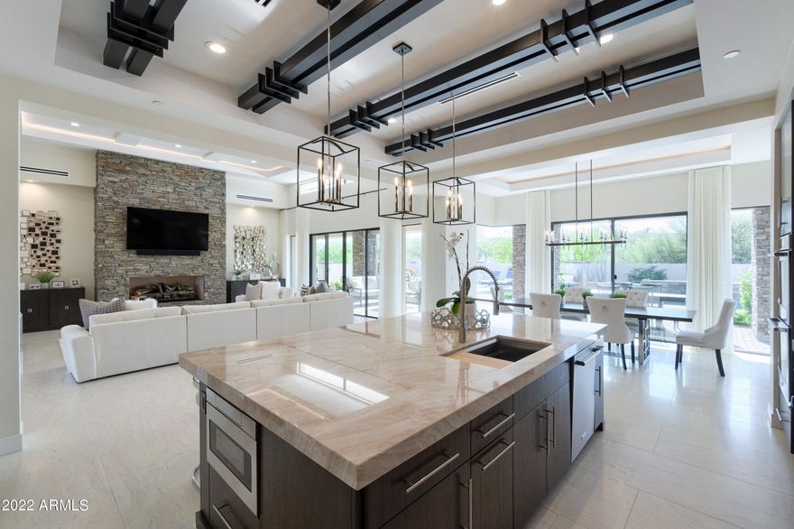 Located in the highly desirable city of North Scottsdale in the gated community of Rio Mountain Estates, rests the most stunning soft contemporary home that defines the luxury of Arizona living. Step inside the open concept floor plan, which boasts 4 bedrooms and 3.5 spacious bathrooms. This beautiful home features seamless indoor/outdoor living which creates an inviting space for entertaining and resort-style relaxation. A stunning chef's dream kitchen featuring top-of-the-line stainless steel appliances, Rift Oak wood cabinets, oversized natural quartzite island, large prep-sink, wall-mounted pot filler and custom hood, along with the spacious game room with bar tap is perfect for all your family fun gatherings. 

The lavish primary suite offers a grand bathroom with an oversized marbl walk in shower and separate soaking tub.  Large sliding glass doors in the living room bring you to your own private oasis pool and spa complete with built in BBQ and custom fire pit. Along with LED energy efficient lighting and SmartHome Control 4 technology throughout the entire home. As any homeowners dream, this 1 acre property is complete by offering unforgettable views of natural landscape and grand mountain views of Four Peaks, Mazatzals, McDowell and Granite Mountain.