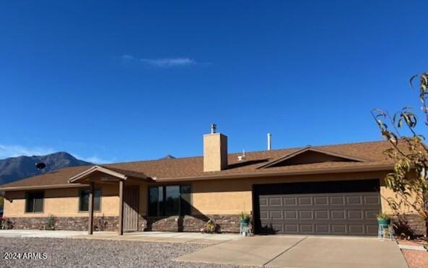 COUNTRY LIVING AT IT''S FINEST!! This Immaculate, Well Maintained Site-built Home is located on a Paved Road on 2 Acres with Dual Pane Windows, Whole House Water Concepts Filtration System, RV Hook-up, 2 Storage Sheds, Ceiling Fans Throughout, Exterior 3-sided 13'x36' Shelter, Rainwater Reserve Tank, Enclosed Arizona Room with French Doors, Locking Hide-a-Safe in 2 bedrooms, Cordless Faux Wood Blinds, Fruit Trees and MORE! All 2 Acres are Fenced & Cross Fenced with RV Gates & Pedestrian Gates. Tile Flooring throughout - NO CARPET! Propane Tank is Owned. The large kitchen is a chef's delight with wall to wall cabinets. Check out the 2-car garage with additional cabinets for all your storage needs! This is also HORSE PROPERTY with AMAZING VIEWS! This home is a must see to appreciate!