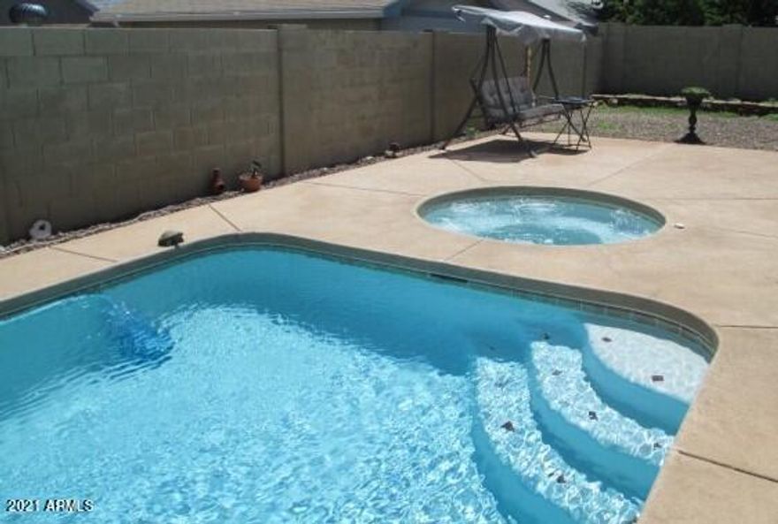 SPLISH, SPLASH!!! This 4 bedroom/2 bath ALL tile home has an open floor plan with very little outside upkeep or yard maintenance so you can spend your time enjoying the cool waters of the LARGE POOL or warming up in the spa! There is room to park your RV and NO HOA!!! New Dishwasher, electric range, Hot water heater and a handicapped step-in bath was recently installed. Located in popular Mountain Ridge complete with a 2-car garage and mountain views makes this a ''must see'' home! Call listing agent for a private showing.