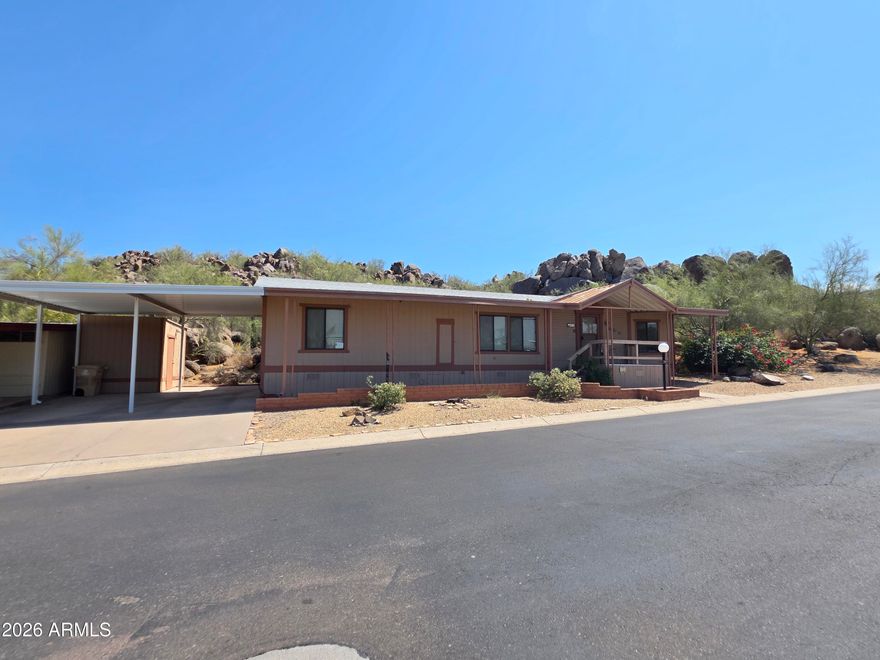 Great opportunity to own a mountainside home with a rare backyard setting showcasing magnificent mountain and boulder views--tranquility at its best. This spacious 18x60 single-wide offers 1,080 sq ft with a split floor plan, laminate flooring in kitchen and bedrooms, large bedrooms with walk-in closets, and a generous pantry. Home has great potential to update to your own style. Enjoy the large rebuilt wood deck overlooking stunning boulders, mountains, nature, and wildlife, creating one of the most peaceful settings in the community. Located in Boulder Ridge, a gated 55+ community. Buyer must be park approved: 750+ credit score, verifiable income 3x lot rent, proof of savings equal to 6x lot rent, and background check. Lot rent $1,010/month.