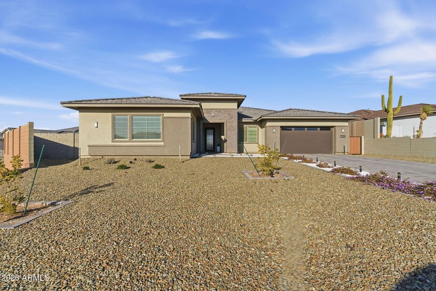 What an incredible premium hillside lot in the beautiful Whispering Hills neighborhood at the base of South Mountain! This Pinnacle Floorplan has over 3600 SF w/4 Bedrooms & 3.5 Bathrooms. Split Bdrms & Home Office. Seller paid for all the right PREMIUM features... Soaring 12' ceiling w/CORNER Sliding Glass Door out to patio, Modern Iron Front Door, Added Exercise/Bonus Rm, Upgraded Flooring, Custom Tile Master Shower w/Raincan Head & Frameless Walk In enclosure. Gourmet Kitchen includes upgraded Cabinets & Quartz Countertops, Beverage Center, Premium Cafe' GE Appliance Pkg: 36'' Gas Cooktop, Double Ovens & Commercial S/S Vent. Champagne Bronze TOUCH Kitchen Faucet & Pot Filler. Baths have Matte Black Fixtures w/raised Vanities & Rectangle sinks for a modern look. Make this your new HOME! Added Upgrades:

12" Ceiling Height in Great Room       
Contemporary Iron Front Entry Door w/Lever Matte Black Hardware   
Finished Bonus Exercise/Game Room 
Extended Corner Sliding Glass Door
Upgraded Aristokraft Cabinets Throughout
Grade 5 Quartz Countertops
Cafe' GE Appliance Package
36" Cafe' Gas Cooktop
Champagne Finish Pot Filler
Super SingleBowl Kitchen Sink
Champagne Finish TOUCH Faucet
Beverage Center
Commercial 36" S/S Vent
Custom Shower Tile Surround w/ Frameless Walk In Shower Enclosure
RainCan Shower Head with Watersense & Sep Valves
Raised Vanities all Baths w/ Rectangular Vanity Sinks
Matte Black Bath Plumbing Fixtures
Soft Water System
Gas Line Stub out for Backyard
Premium Oversized Hillside Lot (.46 Acre)
Insulated Garage Door
Prewire for Pendant Lights
Ceiling Fans & Prewire w/Sep switch for Fan & Light
Full house Window Blinds 
Floor outlet in Great Room 
Additional Outlet
10' RV Gate
   

Standard features are: 

400 AMP Electrical Panel

SMART Features: Switches, Thermostat, Front Entry Door, Doorbell & Garage Door Opener.   LED Disc Lighting per Plan, USB Port @ Kitchen & Primary Suite with Duplex Charger.

Energy & Earth Friendly features:
LEED Certified Home, 16 Seer Lennox Air Conditioner System, Fresh Air Intake & R8 Flex Duct System, Tankless Gas Water Heater, Low E Dual Pane Vinyl Frame Windows, Sprayed Cellulose Insulation in Exterior Wall, Low Water Plumbing Fixtures & Toilets, Post Tension Foundation System.

All Interior paint to be Low VOC