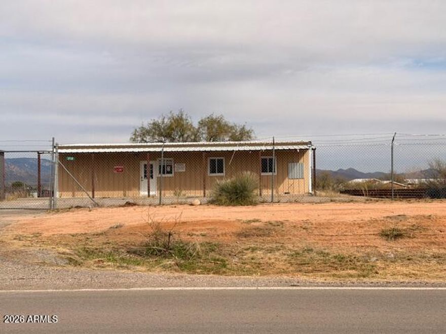 Prime Commercial Opportunity with I-10 Exposure!   Conveniently located just off I-10 at the J-6/Mescal exit, this property offers outstanding visibility and easy access via a paved frontage road (Meadowlark). The 1,482 sq. ft. metal building sits on 0.80 acres and is fenced with chain-link and razor wire for added security on frontage rd. . East and north fence are wood.   The site features paved parking and General Business zoning in rural Cochise County, making it ideal for a wide range of uses. High-traffic I-10 frontage in the J-6 Mescal area provides excellent exposure—perfect for a feed store, small equipment repair shop, or other commercial ventures.  One of the owners is a licensed real estate agent in AZ.