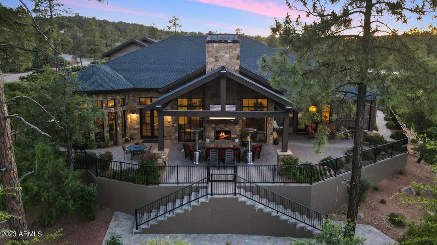 Mountain elegance with the WOW factor! Built by a builder for himself, so much to admire and appreciate. This beauty is nestled on just under 1 acre of landscaped art and has water on 2 sides with mountain views. Driveway and patios are oversized and done in Aker 4 piece desert blend pavers. Siding is a concrete board with a 50 year GAF asphalt composition shingle roof with metal accents. Custom large front door is highlighted by elegant chandeliers both inside and out. Flooring is engineered hard wood throughout and Italian marble in all baths. 14' ceilings boast faux beams and all fireplaces are gas and covered in Telluride blend stone to match the exterior of home. Kitchen is an entertainers delight and a chefs dream. All appliances are SS Wolfe Subzero and cabinets are solid wood soft close with upgraded handles and lots of storage. Large kitchen island can seat many guests and Butler's Pantry can host wonderful evening gatherings. Home has 4 bedrooms with a possible 6, 2 offices, 3 bedrooms are located above garage, 2 family rooms, formal dining room, separate sitting room with FP, Childs play room, and a heated and cooled work out room with mirrors. Energy efficiency is a trademark of this builder with spray foam insulation and all electric minus the FP's and gas cooktop. Garage is a dream and holds 5 cars and has epoxy flooring. Outdoor living can easily be done from the covered patios and built in BBQ and there is even a firepit to enjoy the cool starry nights. So much to mention with all this home holds. Please visit the documents tab for the Features Sheet and further description. You won't want to miss this one.