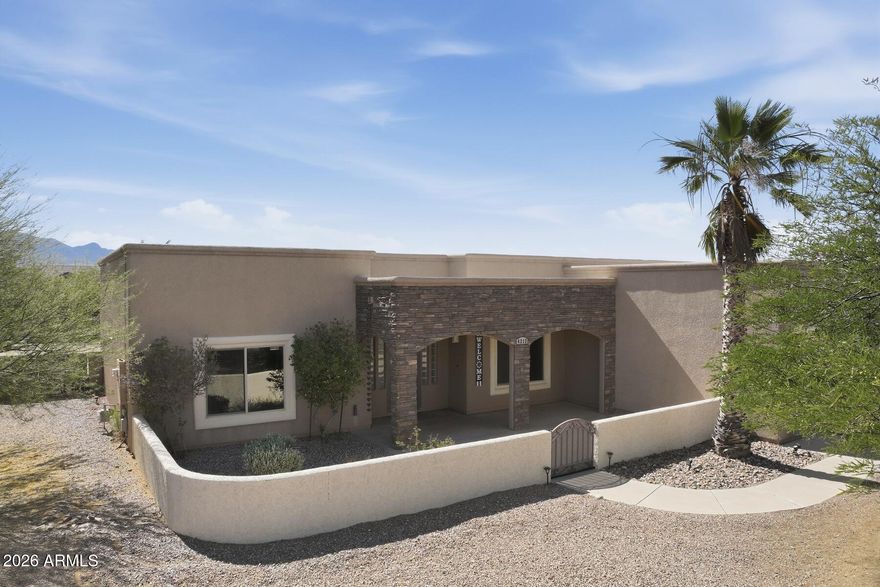 Beautiful Santa Fe-style home situated on a cul-de-sac 1/2 acre lot with breathtaking, unobstructed views of the Huachuca Mountains! This 3 bedroom, 2 bath split floorplan offers 2,042 sq ft of open living space with all tile flooring throughout. Additional flex space is perfect for a home office or formal dining area. The spacious kitchen and living areas flow seamlessly for comfortable living and entertaining. Step outside to the huge covered patio and enjoy the stunning mountain scenery year-round.  Backyard features include a storage shed and chicken coop. Gorgeous exterior stonework adds exceptional curb appeal. No HOA