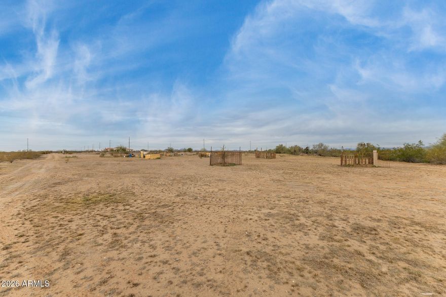 Be the proud owner of this 2-acre vacant lot! Exceptional opportunity to build your custom home in a peaceful setting surrounded by sweeping mountain views. The property is fenced, level, providing a beautiful desert landscape and a blank canvas to design your ideal retreat. Enjoy the convenience of easy freeway access while still feeling tucked away in a serene environment. The lot features a shared well and electricity available nearby. Septic and sewer systems are not currently in place, giving buyers the freedom to plan according to their needs. A rare chance to create a custom home that captures both privacy and breathtaking scenery. Make it yours today!