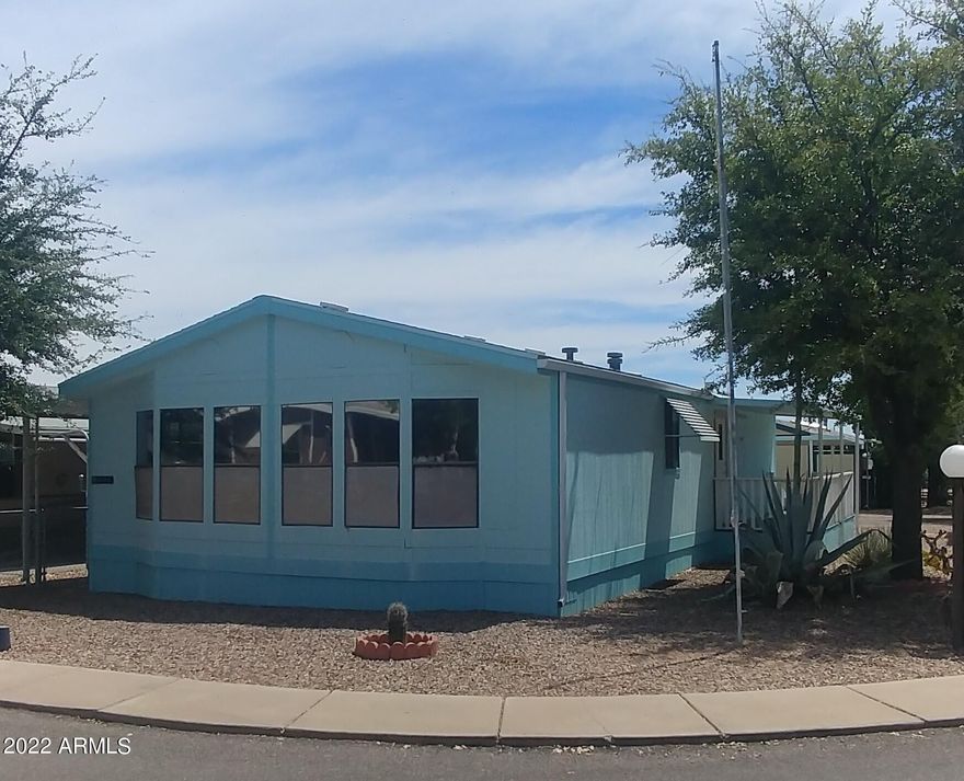 2 bedroom, 2 bath, open living room with many windows  to let the light in!  Laminate flooring in living areas and hall. Nice sized walk in closet in Master bedroom. Good storage in kitchen, large utility room with room for upright freezer or more storage. Corner lot includes a one car enclosed garage (approximately 12x20) and an additional storage building. Sierra Vista Village offers a gated community. 2 club houses. 2 swimming pools, one is an inside pool. Spa, laundry, exercise room, library, children's play ground. Gates open from 6:00AM to 6:00PM. Lot rent includes water, sewer, trash and cable.