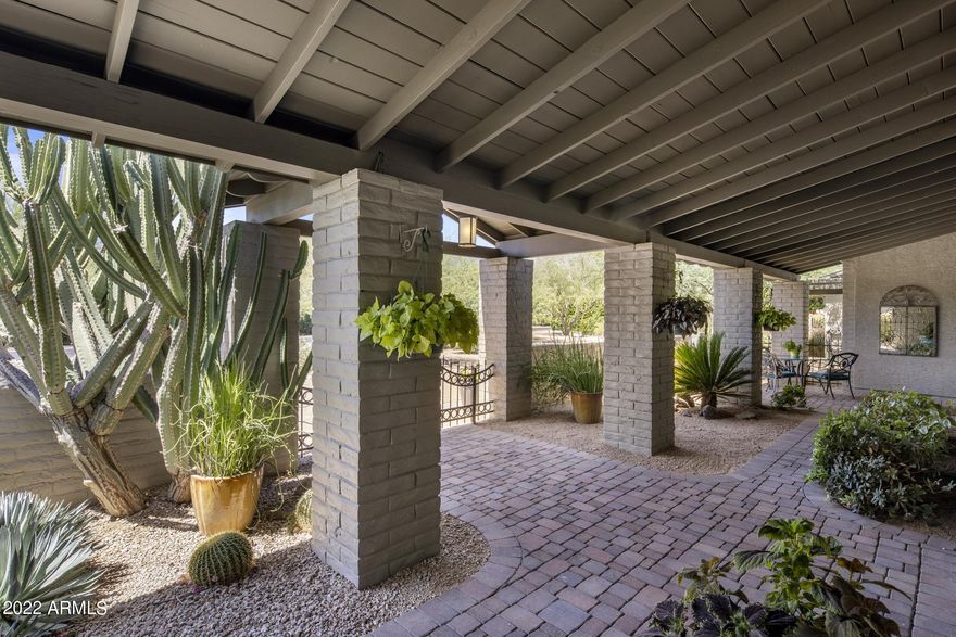 LOCATION, LOCATION, LOCATION!  The tried-and-true rules of real estate still ring true!  This lovely Arizona ranch home is situated in the coveted stretch of Paradise Valley between Camelback and Mummy Mountains. 
The gentle slopes of Mummy Mountain allow for beautiful walks surrounded by mountain views and the central Lincoln corridor location is perfect for bike rides that lead you to world-class resorts like the Omni Scottsdale, Mountain Shadows Resort, JW Marriott Camelback Inn, the new Ritz-Carlton, and the future Palmeraie along with all the dining, spa, shopping, and golf opportunities they offer. Trader Joe's, AJ's, Walgreens, and even a pleasant bike ride to Old Town Scottsdale round out the amenities this location offers! Paradise Valley is conveniently located to Scottsdale's Private Airport and Phoenix Sky Harbor, making travel in and out of Phoenix a breeze. 
 
The 1-acre level acre lot with north-south exposure, on this quiet street, welcomes you with beautiful cacti and a circular paver drive that leads to an expansive covered porch and entryway.   Originally built in 1965, this slump block home has been updated and expanded over the years to create a spacious, lovingly cared-for family home with 5 bedrooms and 3.5 baths, plus an office and detached workshop/garage while keeping its original Paradise Valley charm. The high ceilings in the main living areas of the house create open, sunny spaces for entertaining and everyday living. The neighborhood is known for its Saturday night happy hours and PV Country Club fireworks viewing over Mummy Mountain on the 4th of July! 

Beyond the wide, wood-carved front door is a proper foyer with a front hall closet that greets guests. A large living room with an adobe fireplace and reading nook span the home from front to back. The living room offers picture windows at the front and double French Doors at the back leading to a covered patio that overlooks the pool, backyard, and Mummy Mountain.  The dining room's French Doors open to the front covered patio, creating an inviting entertaining space. 

The kitchen is central to the home with easy access to the living room, dining room, and family room. A cook's dream, it offers a beautiful brick arch framed Viking, 4-burner gas range with griddle along with a Kitchen Aid built-in oven, convection microwave, Bosch dishwasher, and an island with prep sink and wine rack. A breakfast nook has two sets of French doors that open out to covered patios. One door joins the living room patio and the other joint the more casual patio with easy access to the built-in grill.   A large walk-in pantry and broom closet finish off the kitchen.  The laundry room and half-bath have convenient access to the kitchen, family room, backyard, and pool as well! 

The family room is bright and spacious with relaxing views of Camelback Mountain that set the stage for watching your favorite show or gathering with friends to watch your favorite sports team! There is plenty of room for a huge 4K TV!  An office off the family room, with built-in bookcases, includes a window that overlooks the carport, so you can view your car collection or latest project. It also has convenient access to the backyard and workshop, making any hobbyist happy! 

The primary bedroom has a fireplace and sitting area, with French doors that open to a private grassy sanctuary. The bathroom has double sinks, a commode closet, a jacuzzi, and a shower along with access to the walk-in closet.  Your guests will enjoy a large bedroom with a sitting area and its own roomy bath. The bath has sizable counter space, separated from the commode and shower, along with a walk-in closet. A French door allows guests easy access to the pool and backyard. Two additional bedrooms share a hall bath, with a wide counter and sink, separated from the commode and shower.  The fifth bedroom has traditionally been used as an office or exercise room and offers a variety of reconfiguration opportunities. There is even a built-in cabinet in the bedroom wing hallway for linen, and towels, and provides the often-missing storage in newer homes. 

The serene backyard is a delight to behold across all seasons. The majestic mulberry tree is a showstopper that offers welcome shade in the summer, while hummingbirds visit the rotation of blooming plants. All provide a peaceful view while you enjoy morning coffee. Five fruit trees grace the backyard: two Cara-Cara oranges, a lime, a grapefruit, a tangerine, and even a peach tree! In season, you'll enjoy fresh juices from breakfast to happy hour!

The pool benefits from the shade of the mulberry on summer afternoons, providing options for sun or shade and keeping the water refreshingly cool. A motorized cover helps keep the pool safe, clean, and warm in the winter should you decide to heat it. The pool was recently resurfaced along with an updated pool surround, variable speed pumps, filters, and heaters.
The circular driveway is augmented with a wide side driveway and gate that is approximately 16 feet wide to accommodate recreational vehicles and leads to a 2-car garage and 2-car carport with the added desirable bonus of a large storage room. The office that overlooks the carport along with the workshop is the perfect setup for the chronic hobbyist! 

A large, air-conditioned workshop/garage sits at the back of the property behind the gated side driveway and was remodeled in 2016. It's outfitted with a double overhead garage door, new flooring, a Big Ass Fan, 220 Volts, air compressors, and metal roll-down window shades.  This detached building could be a dream shop for your hobbies or reimagined in so many ways. 

Some of the most expensive homes in Paradise Valley surround this private street, creating a unique opportunity for a buyer.  The level lot, location, and neighborhood are so special that the current owners planned to renovate the home. The permitted architectural plans allow for 4 ensuite bedrooms, an expanded primary suite, and sensible renovations while keeping the original charm and casual Arizona feel that makes this home so special. 

Please see the DOCUMENTS TAB for a list of current homeowner improvements.  

Don't miss this opportunity to own this casually elegant, lovingly maintained home and live in this wonderful neighborhood in Paradise Valley!