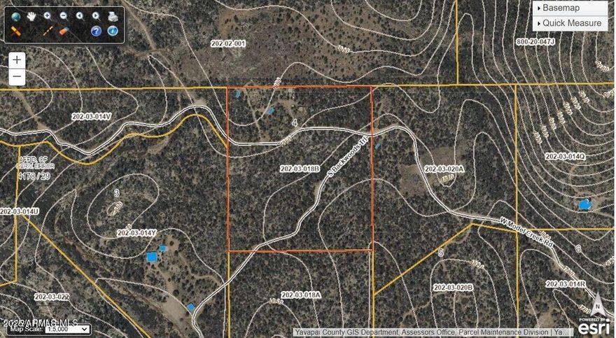 Gently sloping 18.98 Acres in the gated Hyland Park Ranches subdivision just west of Peeples Valley (Highway 89).  Hyland Park is nestled between state land NE and SW, amongst pristine juniper and pinion pine forest with scrub oak and manzanita brush at an elevation of 4900' (NWC) to 4800' (SEC).   There is an unfinished ''off grid'' Rammed Earth tiny home includes: solar (needs new batteries), kitchen cabinets and appliances, wood burning stove, upper loft, bathroom and water heater. Next to this structure is the water well (425' well depth; 22' static water level).  There is a 1500 gal concrete septic vault.  Privacy and security for an ''Off Grid'' site built only (No Manufactured) home. Limited deed restrictions (CCRS in documents tab) allow for great flexibility. OMC/30% down