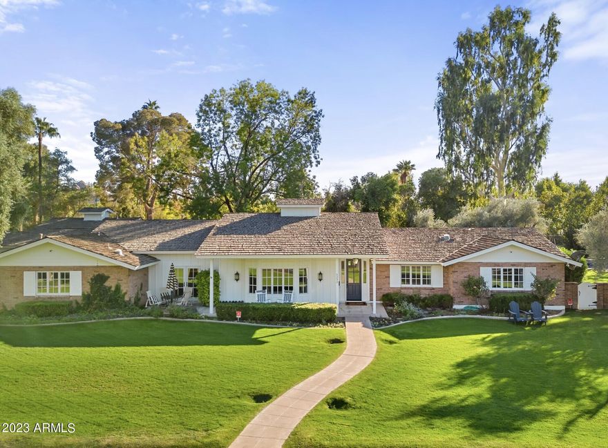 Quintessential Arcadia Living on a large 28,000+ sq ft. lot. This home is an absolute remodeled jewel, with raised 10 ft ceilings, and a beautiful, custom trim package throughout. The floorplan is split and offers a sizable bonus room for various activities. There is a wonderful laundry/ craft room that is not to be missed. The flooring has extensive use of Herringbone brick, wood and marble. The open kitchen is quite charming, with its marble topped island and counters, looking out upon a picturesque backyard. Wrapping the house are inviting patios for friends and family to gather, all accessible through different sets of French doors. The backyard landscaping is lush and mature and features a marvelous private pool. There is a very spacious area for games, and gardens. An ideal location near great schools, downtown Scottsdale, Phoenix and more.