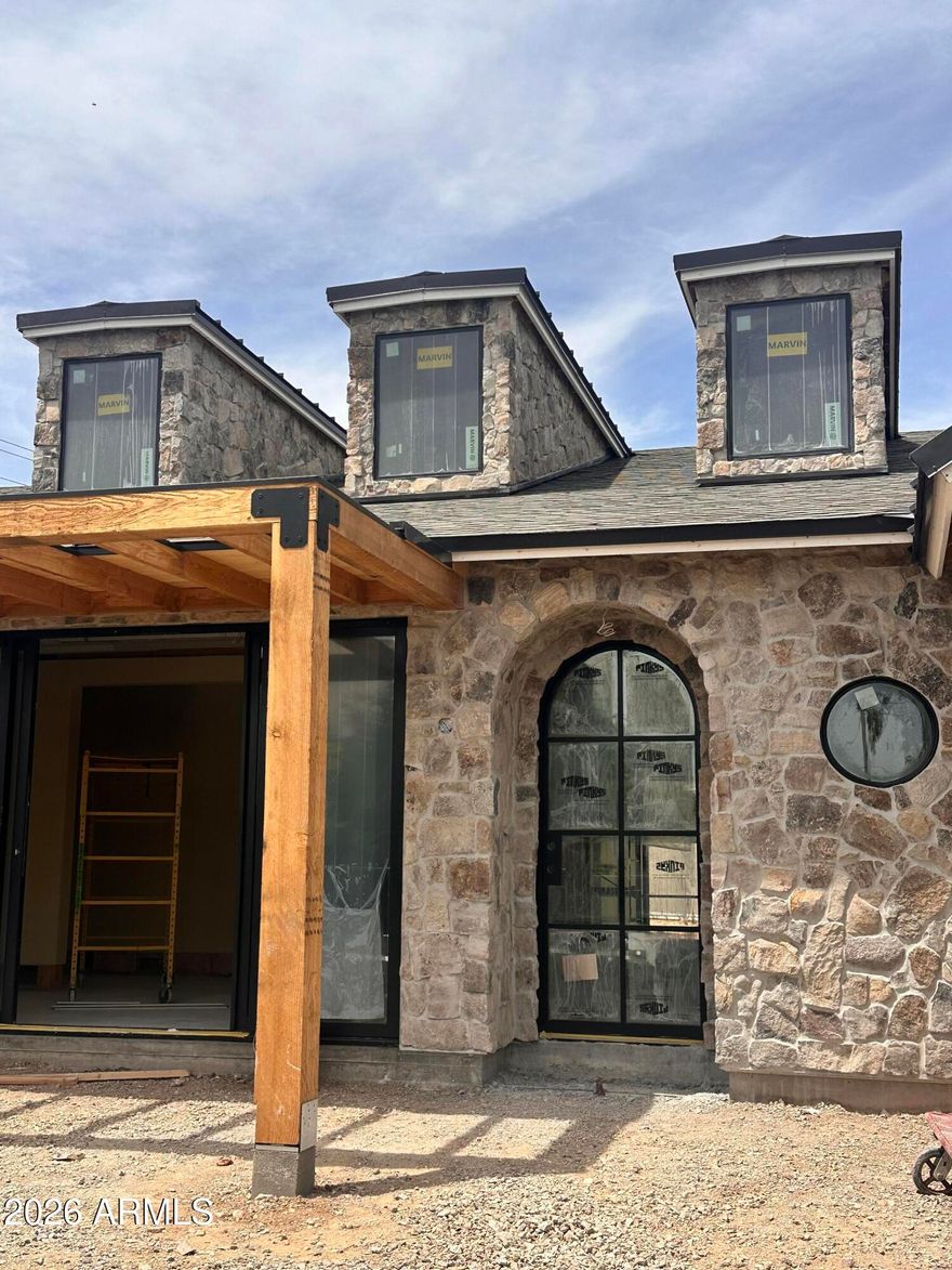 Brand new and scheduled for completion in mid summer 2026, this Biltmore Heights home is professionally designed by Cdot DesignStudio and built by Swartz Construction. The split floor plan offers a private primary suite set apart from the secondary bedrooms, each with its own en suite bath. Designed for both livability and entertaining, the kitchen includes a built in banquette, large island, 48 inch range, double dishwashers, ice maker, and walk in pantry. A formal dining room with built ins adds to the home's function and character. Throughout, exceptional millwork and cabinetry, marble countertops, Marvin windows, a Pinky's front door, and rounded window details reflect the level of design and finish. Outdoor living will include a large covered patio, pool, spa, and water feature. Ideally located with easy access to some of Phoenix's best dining, shopping, golf, and amenities.
