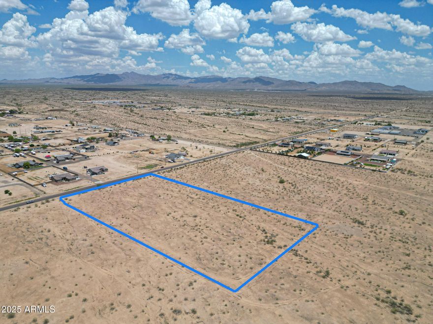 Rare Opportunity Ready for Development! 
A 4.7-acre commercial lot very close to I-10 in rapidly growing Buckeye. Paved access, with electrical access close, a half-fenced lot and a QT being built on the corner lot. Situated along a high-visibility corridor with convenient access to major thoroughfares including I-10 and State Route 85, this flat and buildable parcel offers incredible potential for retail, office, mixed-use, or service-related development. The site supports a wide range of commercial uses, and its strategic location positions your business for long-term success amid a booming residential population and strong economic growth. Land is ready for APS power, and has ability for city water, well water and is touched to pavement road. A great investment opportunity!