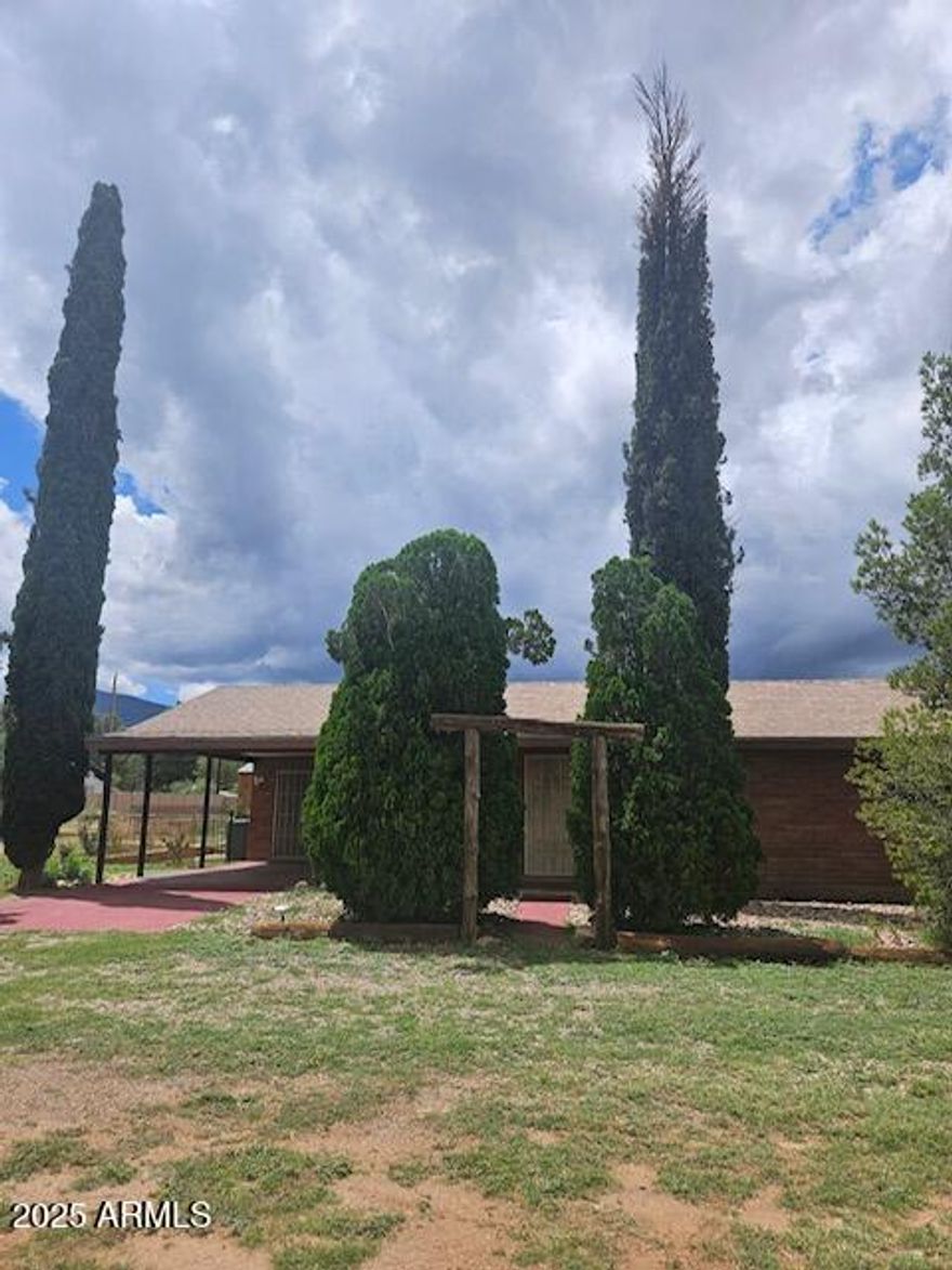 Large price reduction. Motivated Seller! 3 bedroom, 2 bath block home with living room and family room, or fourth bedroom or bonus room with fireplace and closet, you decide! Nice large utility room with plenty of space for storage or a freezer. Most of the windows have been replaced. Home is on a completely chain link fenced acre of Horse Property. A large portion (3 sides) of the chain link has privacy slats to enhance the seclusion.  Also cross fenced with back yard and a potential horse area with a small horse shelter. Ceramic tile and laminate floors through out. AC and newer mini split. Multiple sheds for all your treasures! One would make a great tiny house. Just 5 minutes in to town.