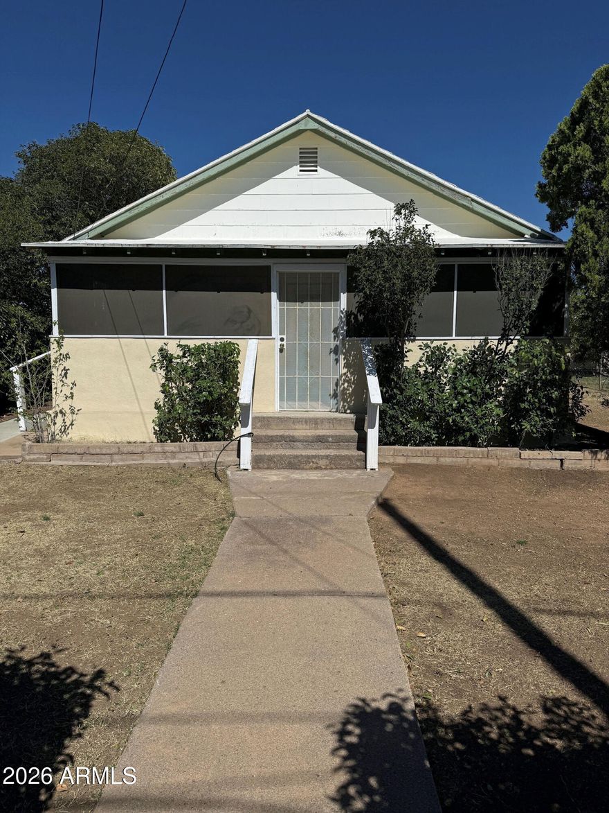 A little TLC = a perfect starter home or retirement bungalow. This 806 sq ft home has 2 bedrooms, a centrally located full bath, a spacious/cool Arizona porch adjoins the living room, convenient eating area adjacent the kitchen, all with central air. Large windows throughout produce a pleasant feeling in each room. Cat owners will appreciate the enclosed large and airy ''Catio'' accessible from the laundry room. Lots of yard space for those ''raised bed'' gardens so popular these days. Located on little over a quarter acre with a handy 12 X 20 shed/workshop, just waiting for the craftsman or hobbyist plus a full one-car garage, both with electric.  The perimeter is fully chain link fenced with privacy hedges here and there.  Home is sold ''as is''.  Seller has never lived in home. see More Gas dryer, gas hot water heater, gas stove ----- cheaper than electric......