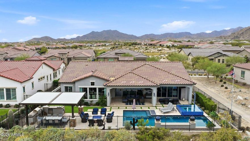 Experience resort-style living in the highly sought-after David Weekley Serendipity model, ideally positioned on Victory's Hole #12 with breathtaking mountain and fairway views. This impeccable maintained residence showcases a sophisticated neutral palette with designer upgrades throughout. The gourmet kitchen is a the heart of the home, featuring GE Cafe Appliances with gas cooktop, dual ovens, Kings Bottle Fridge, Wine Fridge, and oversized walkthrough pantry. Kitchen flows effortlessly into the great room - perfect for entertaining. Offering 3 bedrooms, including two guest suites with ensuite baths. The primary residence has a larger slider overlooking the backyard and an extended walk-in shower and tub with a custom-designed closet. Office/Den is appointed with glass French doors. Now step outside to an entertainer's dream backyard with a resort-style pool and spa, pergola with a built-in outdoor kitchen with BBQ cooktop, 2 cook-top burners, beverage fridge, sink, and more. There are multiple gathering spaces ideal for hosting, including an extended covered patio and a built-in fire pit. A tricked-out 3-car garage completes this home. A must-see to appreciate this move-in-ready, exceptional home!