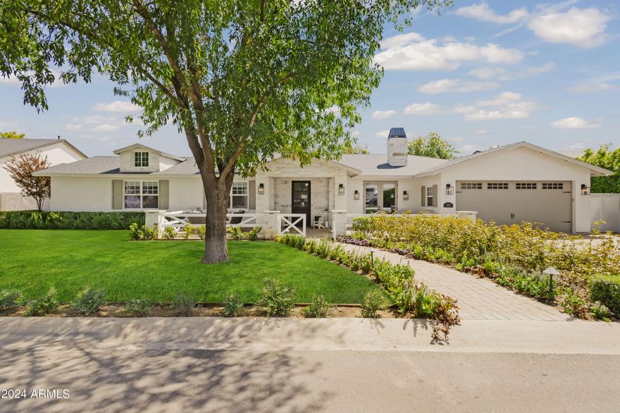 Step into unparalleled luxury in this exquisitely renovated single-level home nestled in the heart of Arcadia Lite! With 5 bedrooms, 5.5 bathrooms, & a generous bonus space, this stunning home seamlessly blends modern elegance & comfort, creating the perfect setting for both serene evenings & lively gatherings. As you arrive, a charming flower-lined walkway guides you to the inviting front patio with Camelback Mountain Views, setting the stage for the beautifully crafted interior. Inside, the gourmet kitchen is a chef's dream, boasting Wolf/Sub-Zero stainless steel appliances, panel-ready cabinetry, two expansive islands, Taj Mahal quartzite countertops, & custom cabinetry that elevates both style & function. Retreat to the primary suite, a true sanctuary with its own cozy fireplace, doors to patio, custom wallpaper, designer finishes, a luxurious soaking tub, and an impressive closet complete with a washer and dryer for ultimate convenience. The outdoor oasis in the backyard boasts lush landscaping, a heated pool/spa, low-maintenance turf, a putting green, a firepit, a large covered patio with misters & a built-in BBQ, and so much more! This home also boasts an oversized 2.5-car garage and an RV gate with ample parking, offering plenty of space for vehicles, recreational toys, & all your storage needs, perfectly blending functionality with convenience & style. Located in the heart of Arcadia Lite, you're just minutes away from LGO, Kachina Park, The Global Ambassador, and all the Arcadia hot spots. This home is a must-see!