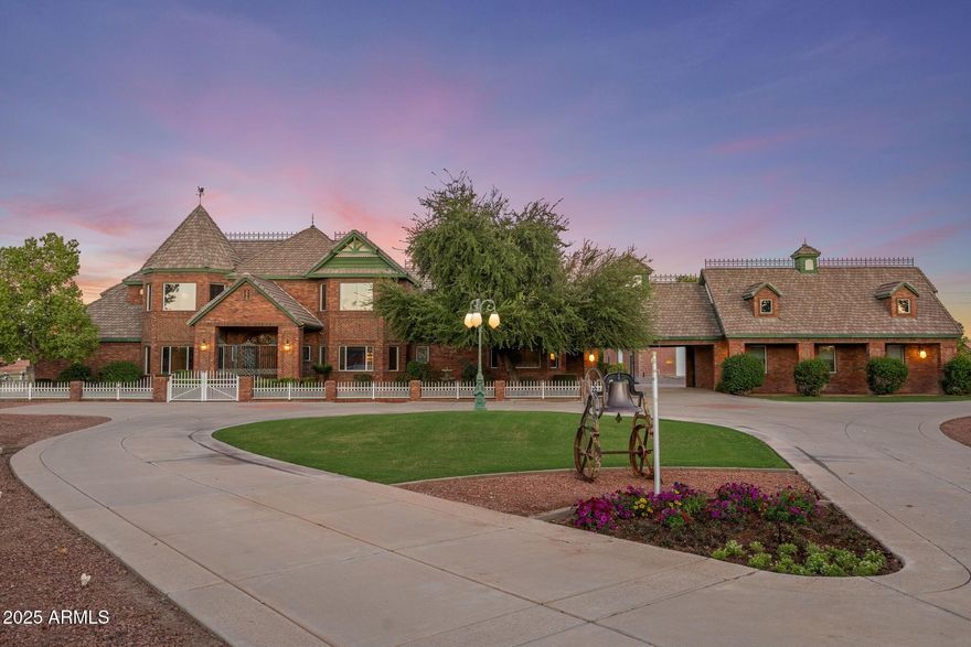 Where timeless elegance meets Arizona heritage — this iconic Victorian-inspired estate rests on 6.175 irrigated acres in the heart of Gilbert, offering an unmatched blend of luxury, privacy, and equestrian living just minutes from vibrant Downtown Gilbert and SanTan Village. Spanning 6,831 sq ft with 5 bedrooms and 7 bathrooms, the home showcases 12' ceilings, a sweeping grand staircase, stained glass details, and handcrafted millwork throughout. The main-level primary suite features dual walk-in closets, while the fully finished basement includes a kitchenette, full bath, and generous storage. Step outside to a resort-style pool, lush irrigated grounds, multiple covered patios, and full equestrian amenities including a 36×64 shop, hay barn, and stalls. With no HOA, a private gated entrance, and room to roam, this Gilbert landmark offers elegance, freedom, and legacy living. If privacy, history, and horses are your love language, welcome home.