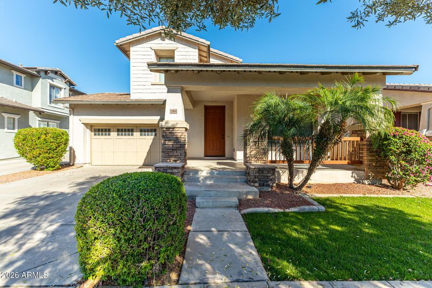 Welcome to the heart of Marley Park, where charm, comfort, and lifestyle come together in one of Surprise's most sought-after master-planned communities. With a new AC installed in 2026 and a newer roof replaced in 2022, this beautifully maintained two-story home offers the major updates buyers want most, along with the charm and community Marley Park is known for.

The home immediately captures attention with the quintessential Marley Park front porch, complete with stacked stone accents and an oversized covered front porch that creates a warm, inviting first impression.

Inside, the freshly painted interior offers a bright, updated feel with thoughtful upgrades throughout, including brand-new carpet, black door hardware, updated black cabinet hardware, upgraded faucets, and an updated dining room chandelier. One of the standout features is the complete upgrade of all flush-mount ceiling lighting throughout the home to modern LED fixtures, giving every space a brighter, cleaner, more contemporary feel while also improving energy efficiency and reducing maintenance. Combined with freshly painted walls, doors, and trim, the home feels crisp, refreshed, and truly move-in ready.

Just off the entry, the versatile front flex room features brand-new wood-look tile flooring and can easily function as a home office, playroom, formal living room, craft space, or whatever best fits your lifestyle.

The open-concept floor plan is designed for both everyday living and entertaining, with the kitchen flowing seamlessly into the dining and living areas. The kitchen features white shaker-style cabinetry, white quartz countertops, a spacious center island, and updated finishes that create a clean, timeless look.

One of the home's most desirable features is the downstairs primary suite, offering privacy and convenience with a spacious walk-in closet and easy main-level living. A downstairs half bath provides convenience for guests, while upstairs offers three additional bedrooms and a full bathroom, creating the ideal layout for families, guests, or multigenerational living.

Step outside to a generously sized backyard with low-maintenance landscaping, a covered patio, and plenty of space to relax, entertain, or simply enjoy Arizona living without the upkeep. The two-car garage adds additional storage and convenience.

Living in Marley Park means more than just owning a home, it means being part of a true community. Residents enjoy three resort-style pools, a clubhouse, splash pad, 26 uniquely themed parks connected by the scenic Arbor Walk, community events, clubs, and year-round activities that make this neighborhood one of the most loved in the West Valley. Located near top-rated schools, shopping, dining, Prasada, sports venues, and entertainment, this home offers both lifestyle and location.

This is the perfect opportunity to enjoy the Marley Park lifestyle with the space, updates, and floor plan buyers are looking for.