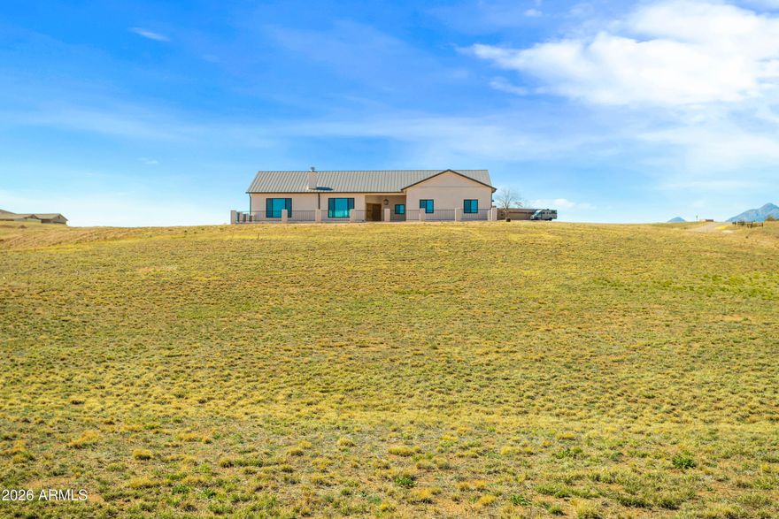 Attention to detail makes this Beautifull Custom-built 2000+sq. ft. home a must have. On a premium high knoll 4.13-acre lot enjoy amazing views of the Mustang and Santa Rita Mt. ranges. Star lite night skies from all directions. Inviting front courtyard with covered entry.  Wood tile floors throughout. Large great room, Living area complete with corner wood/gas fireplace. Kitchen perfectly done w/ high-end finishes. Alderwood cabinets, black stainless steel appliances Quart's counter tops island/breakfast bar. Double door pantry cabinet. Primary suit with large picture window allowing for natural sun light. Onset bathroom, his and her vanity tile surround shower. 2 additional guest rooms. Located in the Santa Cruz Wine country. Where the Deer and antelope roam. no HOA