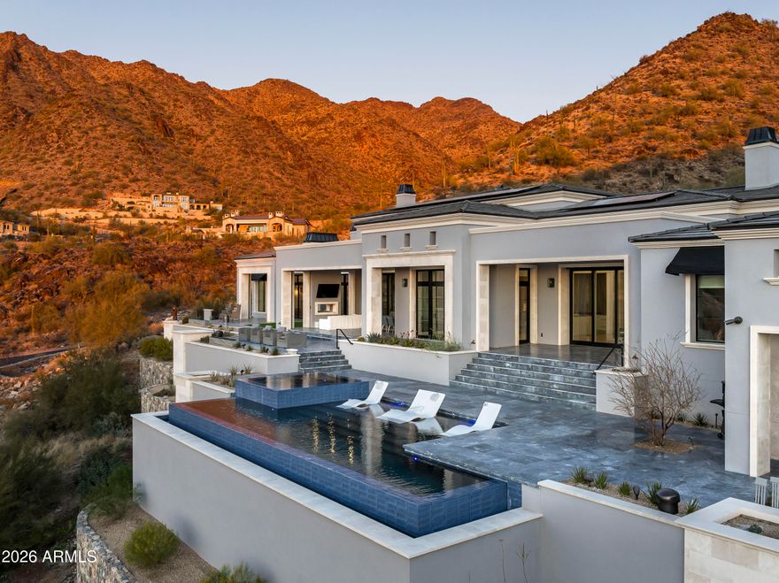 Surround yourself with the highest level of luxury in this recently completed home in the Summit at Silverleaf. A Modern Formal Mediterranean estate with the highest quality features and finishes including; 7 foot tall book matched quartzite kitchen backsplash, soaring 21 foot ceilings in the kitchen, great room, dining room and office. The 4 car garage has 12 ft ceilings, ready to install lifts to double the capacity. The back yard beckons with an infinity pool, raised hot tub, see through fireplace, putting green and amazing gas fire features. Enjoy all of this with unparalleled views of the McDowell Mountains and city lights. This sanctuary includes sustainable features such as solar panels, spray foam insulation and high efficiency windows/doors as well as the lates Control4 smart home automation. Silverleaf, located in North Scottsdale, Arizona, is a prestigious guard gated community known for its luxurious estates, exclusive golf courses, private Club and stunning desert landscapes. 

 

The Tom Weiskopf-designed Silverleaf Golf Course is a highlight for golf enthusiasts. With a blend of Spanish and Mediterranean-inspired architecture, the community offers a high standard of living, including upscale amenities like spas, fine dining, and exclusive shopping. Residents enjoy a harmonious balance between modern luxury and the natural beauty of the desert environment, making Silverleaf a sought-after destination for those seeking an exceptional lifestyle in North Scottsdale. Silverleaf, located in North Scottsdale, Arizona, is a prestigious guard gated community known for its luxurious estates, exclusive golf courses, private Club and stunning desert landscapes.