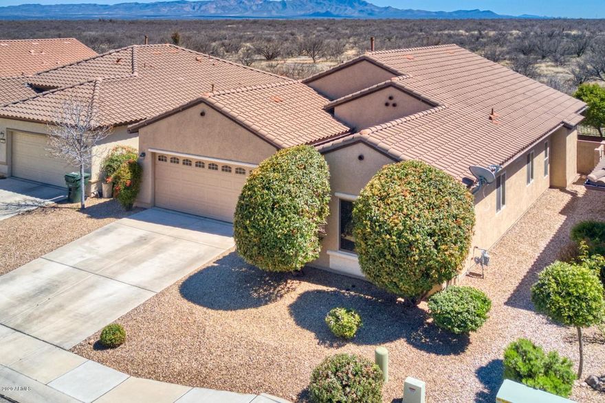 Much sought after family neighborhood and home!  This 3 bedroom 2 bath split plan offers everything you could possibly want!  Inviting foyer with niche and decorative tile that welcomes you into the home.  Tile floors in all the living spaces to include the office/den and carpet in the bedrooms.  The large great room is open to the kitchen and eat-in kitchen area.  The kitchen offers tons of cabinets and counter space perfect for the cook in the family.  Laundry room is enormous with utility sink and room for freezer.  Master bedroom boasts a bay window, dual sinks in master bath with a HUGE walk-in closet with some California closet inserts. Let's not forget about the screened in patio and your unobstructed incredible views of the Huachucas!!  Don't miss your opportunity to call it yours!