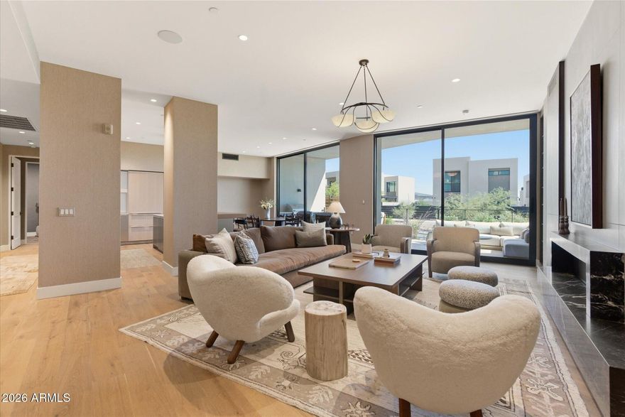 Tucked into the protected hillside at the base of Camelback Mountain, this refined residence offers a rare blend of privacy, ease, and resort-style living within the prestigious Ascent at The Phoenician.
Designed for effortless indoor-outdoor living, expansive retractable glass doors open to a generous private terrace, creating a seamless connection between sophisticated interiors and the surrounding desert landscape. The home offers direct access, single-level convenience, and an effortless lock-and-leave lifestyle. 
Thoughtfully curated interiors feature elevated finishes, open-concept living spaces, and a calm, modern aesthetic designed to complement the natural beauty of the setting. Furnishings by Vallone Design are available on a separate bill of sale for a turn-key experience.  The spacious outdoor living areas invite year-round entertaining, quiet mornings, and relaxed evenings beneath Camelback Mountain.  Residents enjoy access to the private rooftop terrace where sweeping views of Camelback Mountain, the McDowell Mountains, city lights, and Arizona sunsets create an unforgettable extension of the resort lifestyle.
Located within the guard-gated Ascent community, residents enjoy exclusive access to The Mountain Club and world-class resort amenities at The Phoenician's golf, spa, and dining venues.     An exceptional opportunity for buyers seeking refined simplicity, privacy, and effortless luxury in one of Scottsdale's most coveted resort communities.