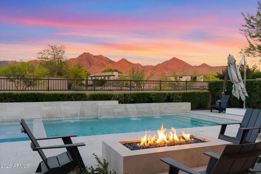 Experience refined desert living in this stunning soft contemporary fully remodeled luxury residence, perfectly situated within the prestigious guard-gated community of Windgate Ranch. This fully remodeled single-story home offers a wide open floor plan, 4 bedrooms, 3.5 baths, Bonus/Play room,  Den/Office or 5th Bedroom and a 3 Car Garage. Thoughtfully designed with an open, light-filled floor plan that seamlessly blends sophistication with everyday comfort. Situated on a premium lot, the property captures sweeping panoramic views of the McDowell Mountains and iconic Tom's Thumb, offering exceptional privacy and a true connection to the surrounding natural desert landscape. Inside, the home showcases an extensive, designer-curated renovation with upgrades that will appeal to the most discerning buyers. Expansive new sliding glass doors open seamlessly to the backyard, maximizing indoor-outdoor living and framing the breathtaking mountain views. The interior is enhanced by wide-plank white oak flooring, all-new LED Lutron lighting throughout, and striking designer 4K chandeliers that elevate each space. The chef's kitchen is both functional and show stopping, featuring all-new appliances, a dramatic waterfall-edge quartz island, a spacious walk-in pantry, and a beautifully appointed wine and beverage bar...perfect for entertaining. Additional enhancements include new interior and exterior paint, new gates, and a custom iron glass front door that creates a grand first impression.The thoughtfully expanded layout includes a private en-suite guest retreat, an oversized bonus/playroom, and a versatile den or office. The luxurious primary suite serves as a serene escape, complete with all-new windows, dual his & her closets, and a spa-like bath featuring a heated towel rack for added comfort and indulgence. Further upgrades include two new A/C units, a new water heater, new garage door openers, epoxy-coated garage flooring, and ceiling fans throughout...ensuring both efficiency and comfort. The backyard has been completely reimagined with all-new landscaping & irrigation, creating a true resort-style setting. Enjoy a brand-new heated pool and spa, multiple gathering spaces including a fire pit and outdoor fireplace, and a fully equipped outdoor kitchen beneath a custom pergola with integrated LED lighting...perfect for evening entertaining under the Arizona sky. Residents of Windgate Ranch enjoy an amenity-rich lifestyle with access to a beautifully appointed community center, resort-style pool, tennis courts, pickleball, and sport courts--enhancing the overall living experience with recreation, wellness, and social connection just moments from home. This is a rare opportunity to own a turnkey luxury home in one of North Scottsdale's most sought-after communities where elevated design, exceptional upgrades, and seamless indoor-outdoor living come together beautifully.