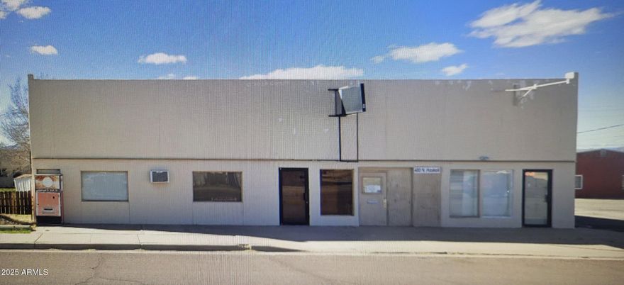 Three retail spaces. Large covered parking garage workshop. mezzanine floor office and storage.  The perfect building for a creative entrepreneur.
