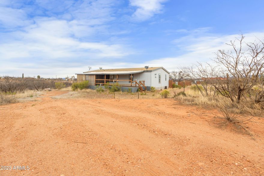 Gorgeous views on this just over 4 acre lot. Crossed fenced and ready. Manufactured home complete with 3 bedrooms and 2 baths, covered porches and outer buildings for animals or storage. Home is being sold AS IS, a great fixer upper you can update and repair to your own specifications. 
Call today for your private showing.