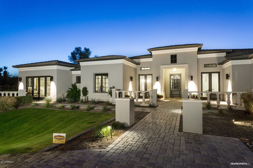 Welcome to your beautiful 2 year old, custom home in Paradise Valley.  This well designed, entertainer's dream home features a split floor plan with 6 bedrooms, 5 1/2 baths, and a 4 car garage. This home also includes a gorgeous chef-inspired gourmet kitchen complete with sub-zero and a Wolf appliance package. Enjoy entertaining? Your new home includes a large media/game room, a full bar, custom wine cellar, fireplace, intricately detailed 14' coffered ceilings and breathtaking, wall to wall views of Camelback mountain. Your private master retreat is complete with a wet bar, fireplace, and sitting area - as well as a luxurious oversized master bath with his/her closets, and vanities, soaking tub and large walk-in shower. This home has a beautifully landscaped large backyard complete with a heated pool, spa and plenty of room.  No detail has been overlooked and it is an opportunity not to be missed.