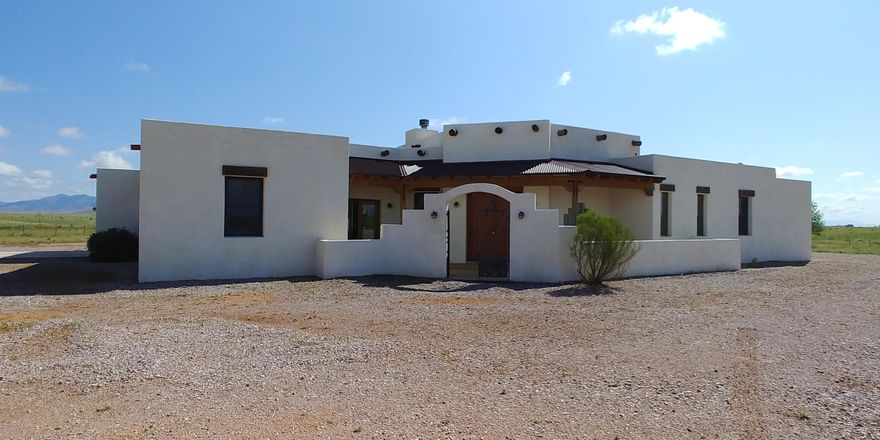 This beautiful home is just waiting for new owners. The sante fe style home continues all thru the home. Open beam ceilings, rustic cabinetry, stamped concrete floors and much more. There is a split plan for privacy. The master suite is huge with an amazing mountain view, large master bath with glass block shower and jetted tub and dual vanities. There is a living room with a fireplace and also another fireplace just off the kitchen. You will love the formal dining room with picture window and built ins too. There is also a HUGE bonus room. There are covered patios to take in the amazing views.