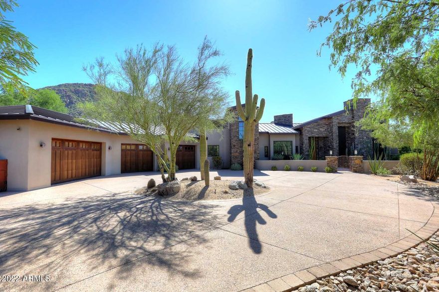 Located in the award-winning prestigious community of Desert Highlands. Immediate Golf membership included at Close of Escrow! Soft contemporary design situated on over a 3/4 acre, very private, peaceful lot with mountain views. Built in 2011, the home has quality finishes, appliances and features. The entry way is in-laid wood and stone flooring with ceilings of wood beams. Real wood and travertine tile flooring.  20+ feet high ceiling couples with a magnificent floor to ceiling stone fireplace. Comfort and elegance. Sunken bar situated off the living room with sink, fridge and granite counters. Adjacent to the customized and elegant powder room is a spacious office/ library with built in shelves and cabinetry. The Primary bedroom is spacious with auto shades, drapes and access to the outdoor spa and pool. Main bedroom suite bathroom area includes floor to ceiling tiled rain shower, Kohler Soaking tub, granite and stone tile counters, separate water closets and sink areas. There is an expansive walk-in closet with 3 walls of wood built-in closets, shelves and storage. 

The multiple large windows in the bedroom allow full view of the resort-style backyard with pool and spa and mountain views.
The kitchen area has a large granite covered island with seating for up to 6 chairs. Full length granite counter with full size cabinets and shelves above. Appliances include a Wolf 6-burner gas cooktop, large double sided Sub-Zero refrigerator, Wolf Double ovens, Asko Full Size dishwasher and a Fisher & Paykel Draw-Type dishwasher, microwave and sub-zero handy 25 bottle wine fridge. 
 Walk-in pantry and casual dining nook off the kitchen. Adjacent to the kitchen is a free-standing stone fireplace and a more formal dining area set up with contemporary drop lighting and room for a hutch.
Down the hallway is the laundry room with granite counters, an includes storage cabinets and newer Electrolux washer and dryer.
Continuing down the hallway on the first floor is an ensuite guest bedroom  with a well appointed bathroom of granite and stone tile.
The hallway leads out to the overly spacious epoxy flooring 4 car garage. With a 10.5 feet floor to ceiling, a car lift can be added. Numerous built-ins along the wall and a 12' x 10 ' storage room can be found a the back of the garage area. The garage is massive in depth and allows for extra car storage.
Back into the hallway, a short flight of stairs takes you to the upstairs ensuite bedroom with private deck overlooking the beautiful backyard.
You can get to the back yard from the living room/ kitchen area, and main bedroom area. A covered back patio area measures over 25' x 20'+. Built-in BQ grill. Heated spa and pool with flora, trees and mountain view. Great entertaining backyard.
This home has it all, is in excellent condition, has had a very limited occupancy and has an excellent exterior curb appeal. 

All new hot water heaters, New HVAC unit, new pool cleaning system, new pool LED light, updated laundry room. All operating systems and structural/roof/sewer have been fully inspected, repaired and are fully operational.
