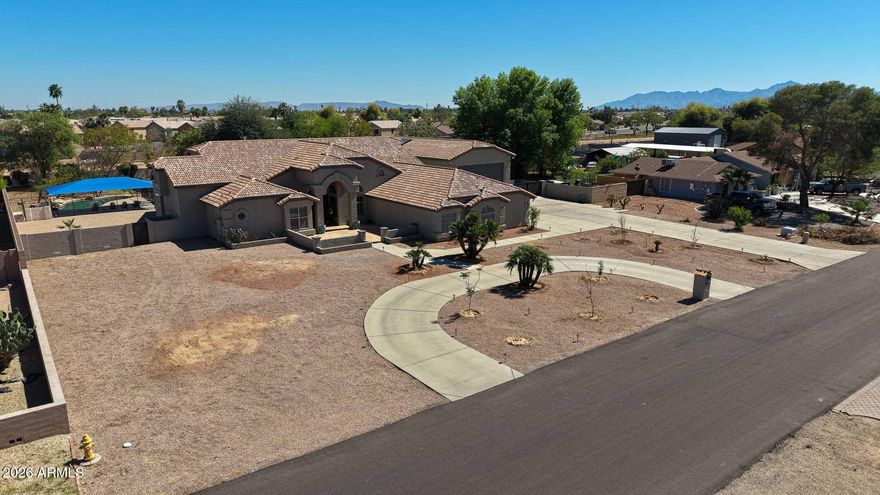 Experience luxury living on a full acre with no HOA--this completely renovated home in Camelback Farms is the total package. Featuring a rare detached 60' RV garage, dual primary suites, RV gate, and endless parking space, this property offers both versatility and upscale design.

Spanning 3,568 sq ft, this 4-bedroom, 3.5-bath home plus den showcases a bright open floor plan with soaring ceilings, smooth-textured walls, and custom Venetian plaster finishes. Expansive 16' and 11' multi-slide doors create seamless indoor-outdoor living.

The designer kitchen is equipped with a large island, quartz countertops, slim shaker cabinetry, under-cabinet lighting, gas range (propane), drawer microwave, and a 42'' Monogram refrigerator. The main primary suite features dual custom closets, a spa-inspired bath with a freestanding tub and separate shower, and private backyard access. A secondary primary suite offers its own en-suite bath--ideal for guests or multigenerational living. Two additional bedrooms share a Jack & Jill bath.

Upgrades include porcelain plank tile flooring throughout, modern interior doors, upgraded hardware, LED lighting with dimmers, shutters, electric fireplace with Venetian plaster surround, water softener, and Bluetooth exhaust fans.

The backyard is built for entertaining with a private pool, pavers, mature fruit trees, irrigation system, and extended patio space.

Additional highlights include a detached 60' RV garage with front and rear access, new iron and wood RV and side gates, fresh interior and exterior paint, 3-car garage with built-in cabinets and owned solar panels. 

Imagine summer barbecues, weekend fun, and quiet mornings on your own acre of paradise--this home is built for the life you've dreamed of.